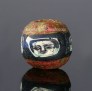 Ancient Roman glass bead with face pattern